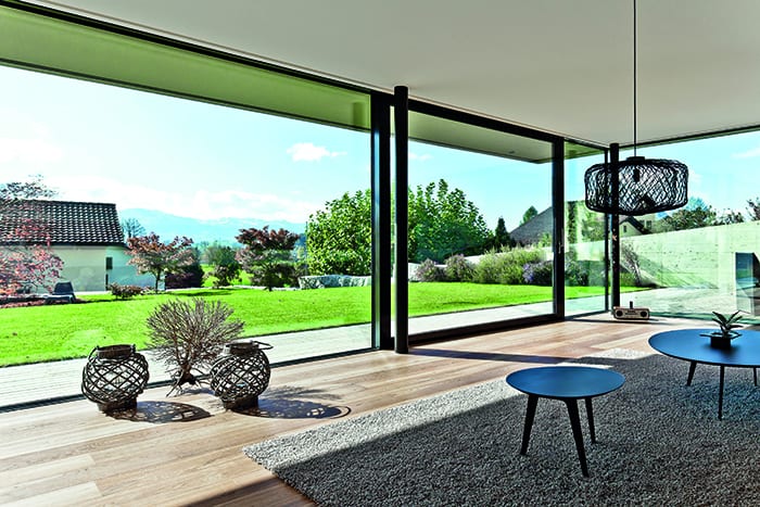 Sliding patio doors help bring the garden into this cool Swiss home