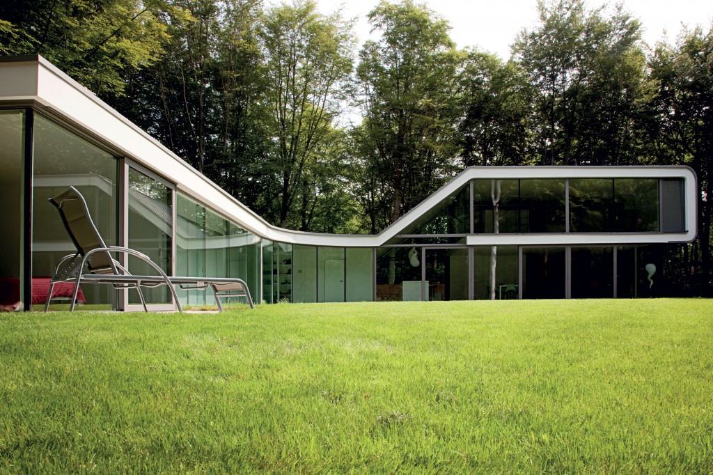 Huge aluminium windows help blend home and garden in this open-plan villa