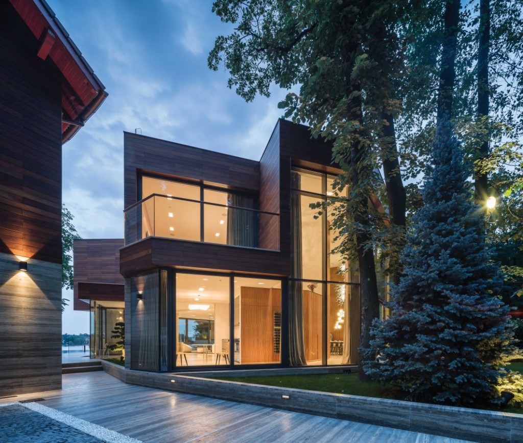 Vast aluminium window systems let light pour into this lakeside villa